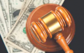 Gavel with one dollar bills underneath 