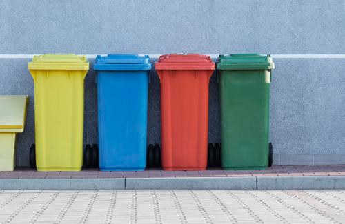 Photo of four different color garbage cans