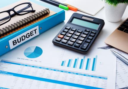 City budget documents with calculator and graphs