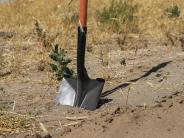 A shovel digs into the ground at the South Hermiston Industrial Park.