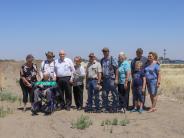 Members of the Cook family stand with a ceremonial road sign during the South Hermiston Industrial Park groundbreaking.