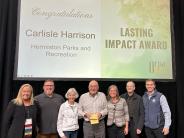 Carlisle Harrison (center) holds the Lasting Impact Award awarded at the Oregon Recreation & Park Association conference.