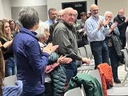 The audience applauds for Carlisle Harrison at Hermiston City Hall
