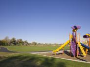 Harrison Park playground, asphalt trail and open space.