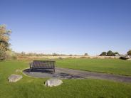 Harrison Park bench and open green space.