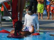 Lifeguard helping swimmer
