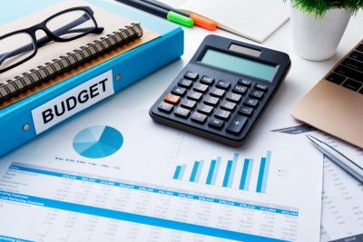 Budget documents with calculator and charts