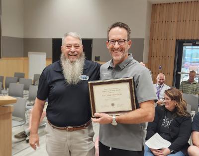 Dave Drotzmann smiling and receiving OMA award at Hermiston City Hall