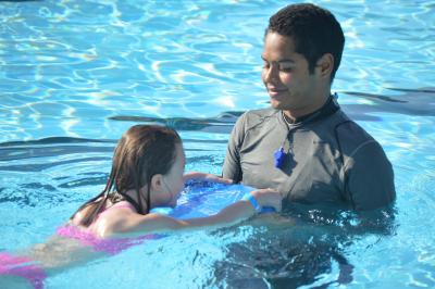 A swim instructor gives a lesson to a child at the Hermiston Family Aquatic Center.