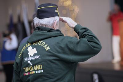 A veteran salutes the flag at 2022 Veterans Day Breakfast