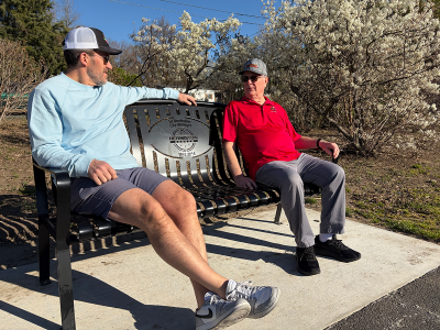 Former mayor Dr. Dave Drotzmann and former councilor Rod Hardin sit on a bench at Riverfront Park