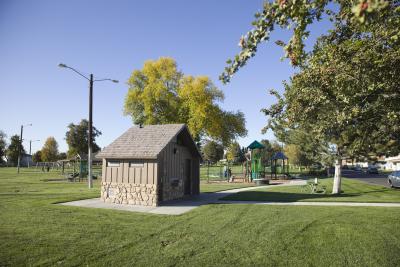 Photo of victory square park, grass and trees.
