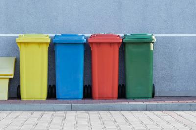 Photo of four different color garbage cans