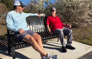 Former mayor Dr. Dave Drotzmann and former councilor Rod Hardin sit on a bench at Riverfront Park